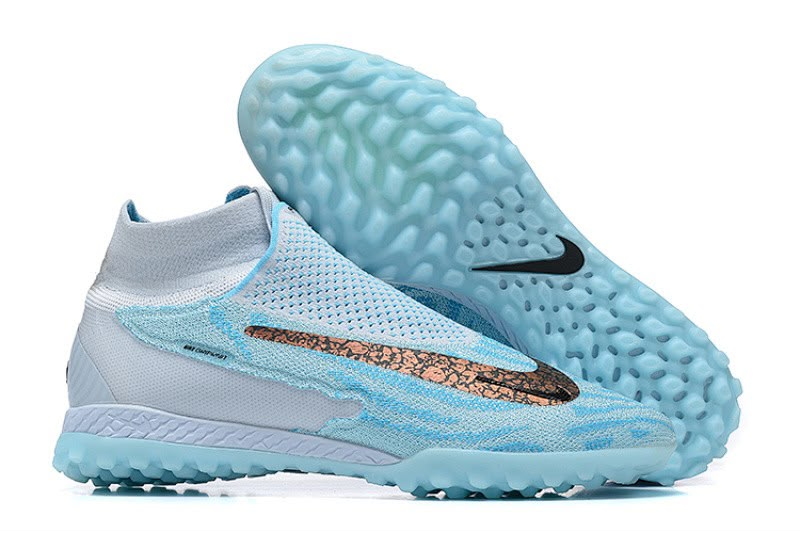 Light blue Nike Phantom GX-style high-top turf football shoes with textured upper, patterned swoosh and light blue TF sole